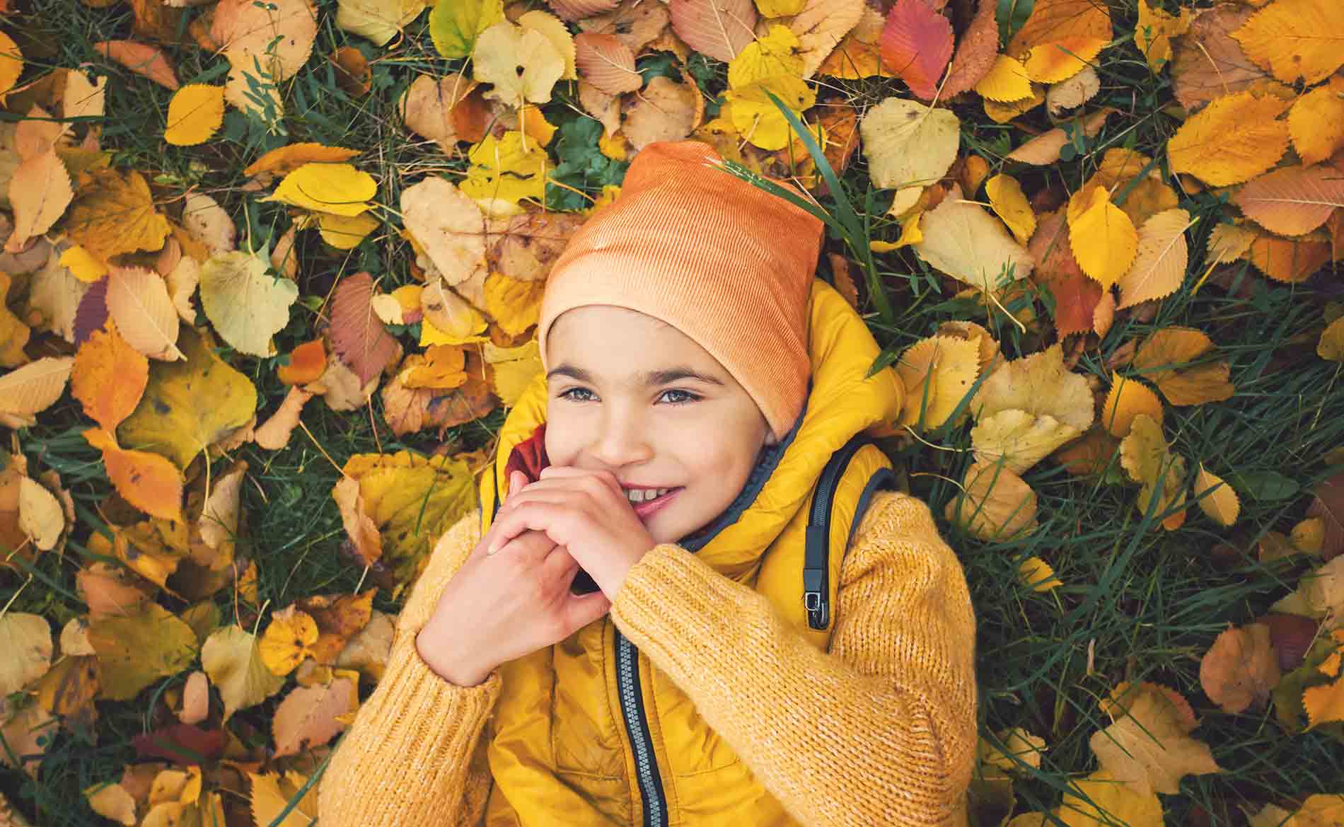 Boy with Cerebral Palsy Playing in Leaves