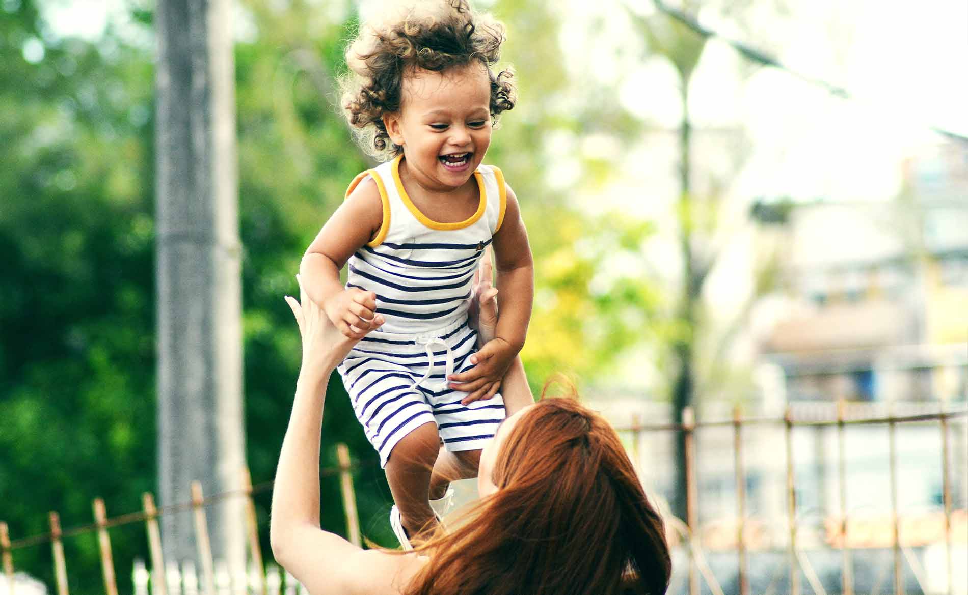 Mother Tossing Daughter in the Air